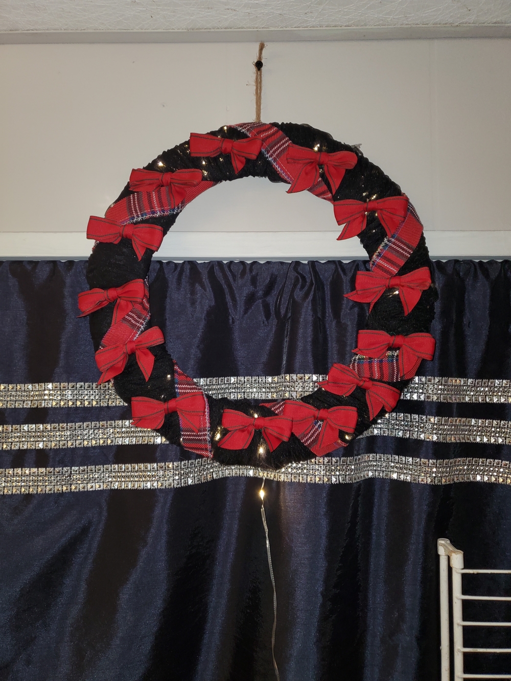 Black Yarn Holiday Wreath with Red Bow Accents